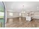 Open floor plan combining the living room and kitchen features hardwood floors and lots of light at 9865 Sw 105Th Ct, Ocala, FL 34481