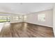 Bright living room features wood floors, recessed lighting, and sliding door access to the lanai at 9865 Sw 105Th Ct, Ocala, FL 34481
