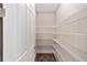 Walk-in pantry featuring wood-look flooring and white wire shelving for ample storage space at 9865 Sw 105Th Ct, Ocala, FL 34481
