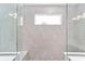 Tiled shower with frameless glass enclosure in a modern bathroom at 9865 Sw 105Th Ct, Ocala, FL 34481
