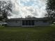 Simple single story home features a screened-in back porch and a large backyard at 11248 Sw 76Th Ter, Ocala, FL 34476