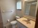 Bright bathroom with a window, vanity, and a toilet at 11248 Sw 76Th Ter, Ocala, FL 34476