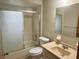 The bathroom features a frosted glass shower/tub combo, a vanity, a toilet, and ample lighting at 11248 Sw 76Th Ter, Ocala, FL 34476