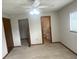 Carpeted bedroom with ceiling fan, closet and ensuite bathroom at 11248 Sw 76Th Ter, Ocala, FL 34476