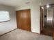 Bedroom featuring neutral walls, carpet, and closet and doorway views to the hall at 11248 Sw 76Th Ter, Ocala, FL 34476