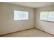 Comfortable bedroom featuring two windows for natural light, neutral walls, and ample space for furniture at 11248 Sw 76Th Ter, Ocala, FL 34476