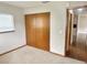 Cozy bedroom featuring plush carpeting, a window with blinds, and a spacious closet for storage at 11248 Sw 76Th Ter, Ocala, FL 34476