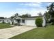 Single-story home features an attached one car garage and a well-manicured front lawn at 11248 Sw 76Th Ter, Ocala, FL 34476