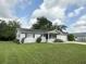 Inviting single-story home with tidy landscaping, traditional shutters, and a one car garage at 11248 Sw 76Th Ter, Ocala, FL 34476