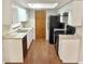 Functional kitchen with matching appliances, light countertops and white cabinetry at 11248 Sw 76Th Ter, Ocala, FL 34476