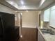 Well-lit kitchen with modern appliances, a double sink, and direct access to the living room at 11248 Sw 76Th Ter, Ocala, FL 34476