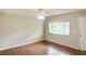 Inviting living room featuring wood-look flooring, a ceiling fan, and a large window offering neighborhood views at 11248 Sw 76Th Ter, Ocala, FL 34476