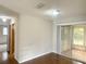 Spacious living area with hardwood floors and sliding glass doors to an enclosed patio at 11248 Sw 76Th Ter, Ocala, FL 34476
