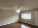 Features hard wood floors, a large window offering natural light, and a ceiling fan at 11248 Sw 76Th Ter, Ocala, FL 34476