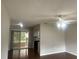 Open living space with wood floors, ceiling fan, and sliding glass doors to the porch at 11248 Sw 76Th Ter, Ocala, FL 34476