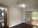 Open living space with wood floors, a ceiling fan, and sliding glass doors to the porch at 11248 Sw 76Th Ter, Ocala, FL 34476