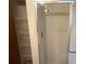Walk-in shower with a chrome shower head and an adjacent storage closet at 11248 Sw 76Th Ter, Ocala, FL 34476