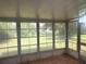 Enclosed sunroom with large windows offering great views of the well-maintained backyard at 11248 Sw 76Th Ter, Ocala, FL 34476