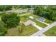 Aerial view of property showcasing the house, outbuildings, and surrounding neighborhood at 12 Hemlock Radial Pass, Ocala, FL 34472