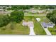 Aerial view showcasing the house, yard, detached garage and neighboring properties at 12 Hemlock Radial Pass, Ocala, FL 34472