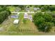 Wide-angle aerial shot capturing the house, large yard, and neighborhood from above at 12 Hemlock Radial Pass, Ocala, FL 34472