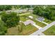 Aerial view of property showcasing the house, outbuildings, and surrounding neighborhood at 12 Hemlock Radial Pass, Ocala, FL 34472