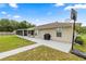 Spacious backyard featuring a large patio perfect for entertaining, with a basketball hoop and adjacent screened porch at 12 Hemlock Radial Pass, Ocala, FL 34472