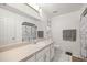 Bathroom with white tile flooring, cabinets with a sink, a toilet, and a shower at 12 Hemlock Radial Pass, Ocala, FL 34472