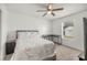 Bedroom with a desk, window, and a ceiling fan, offering a comfortable living space at 12 Hemlock Radial Pass, Ocala, FL 34472