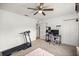 Bedroom featuring a ceiling fan, exercise equipment, and a closet with sliding doors at 12 Hemlock Radial Pass, Ocala, FL 34472