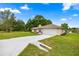 Charming single-story home with a long driveway, lush green lawn, and attached two-car garage at 12 Hemlock Radial Pass, Ocala, FL 34472