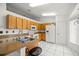 Functional kitchen with white appliances, tile flooring, and plenty of cabinet space for storage and meal preparation at 12 Hemlock Radial Pass, Ocala, FL 34472