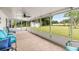 View of the backyard from the screened-in patio, featuring a shed and lush greenery at 12 Hemlock Radial Pass, Ocala, FL 34472