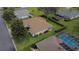 Aerial view of the property showing manicured landscaping and proximity to a pool at 13715 Se 88Th Ct, Summerfield, FL 34491