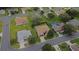 An aerial view showcases this single-Gathering home in a community with mature trees and manicured lawns at 13715 Se 88Th Ct, Summerfield, FL 34491