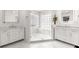 Bathroom featuring marble floors, a glass shower, and double vanities at 13715 Se 88Th Ct, Summerfield, FL 34491
