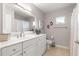 Clean, well-lit bathroom features a large mirror, vanity and walk-in shower at 13715 Se 88Th Ct, Summerfield, FL 34491
