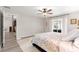 Bedroom with ceiling fan, en suite access, and floral bedding at 13715 Se 88Th Ct, Summerfield, FL 34491