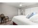 Comfortable bedroom with wood floors, ceiling fan, neutral walls and closet at 13715 Se 88Th Ct, Summerfield, FL 34491