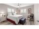 Cozy bedroom with wood floors, plantation shutters, ceiling fan and comfortable furniture at 13715 Se 88Th Ct, Summerfield, FL 34491