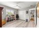 Bright bedroom features wood floors, ceiling fan, closet and large window at 13715 Se 88Th Ct, Summerfield, FL 34491