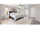 Bedroom with ceiling fan and en suite doors to the bathroom at 13715 Se 88Th Ct, Summerfield, FL 34491