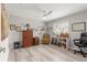 Comfortable bedroom features wood floors, ceiling fan and large window at 13715 Se 88Th Ct, Summerfield, FL 34491
