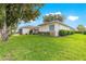 Well-maintained home exterior with lush green lawn, mature landscaping, and manicured shrubbery at 13715 Se 88Th Ct, Summerfield, FL 34491
