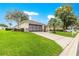 Home with a well-manicured front yard, attached garage, and beautiful landscaping at 13715 Se 88Th Ct, Summerfield, FL 34491
