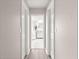Hallway view into bathroom with marble floors and glass shower at 13715 Se 88Th Ct, Summerfield, FL 34491