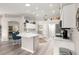 Bright kitchen featuring a central island, stylish bar seating, and stainless steel appliances at 13715 Se 88Th Ct, Summerfield, FL 34491