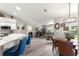 Bright living area featuring kitchen, dining, and seating with hardwood floors and natural light at 13715 Se 88Th Ct, Summerfield, FL 34491