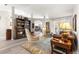 Elegant living room featuring a bookshelf, area rug, and comfortable seating at 13715 Se 88Th Ct, Summerfield, FL 34491
