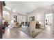 Spacious living room with a vaulted ceiling, elegant furnishings, and access to the outdoors at 13715 Se 88Th Ct, Summerfield, FL 34491